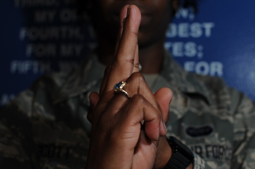 Airman 1st Class Shaney Scott does the American Sign Language sign for honor at the Enlisted Heritage Hall March 24, 2014, Maxwell Air Force Base, Ala. She is fluent in ASL and volunteers as a teacher and interpreter. Scott is a 690th Network Support Squadron enterprise service desk technician at Gunter Annex. (U.S. Air Force photo/Staff Sgt. Natasha Stannard)
 