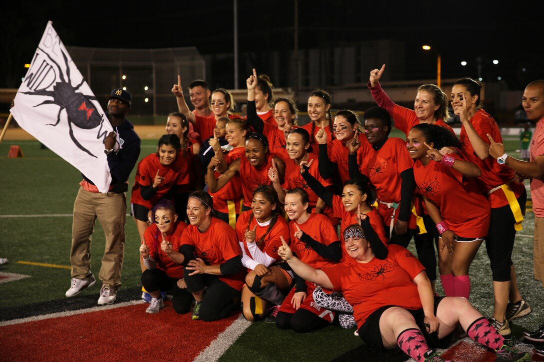 Spouses with Marine Aircraft Group 16 celebrate after winning the Committed and Engaged Spouses Support League “Friday Night Lights” Football Tournament championship game aboard Marine Corps Air Station Miramar, Calif., March 28. The trophy was presented to the team by Maj. Gen. Steven Busby, 3rd Marine Aircraft Wing commanding general.