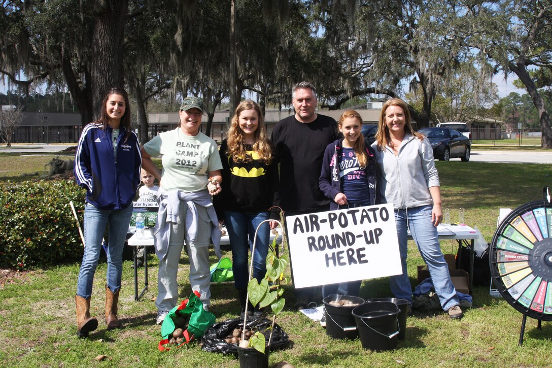 The air potato roundup is a family-friendly event where even young children like Shane Huebner, age three (seated at table) can participate, since it’s almost like an Easter-egg hunt. Pictured left to right, Stephanie Dean, Liane Patrylo, Riley Lane, Jon Lane, Madi Lane and Angie Huebner all volunteered at Montclair Elementary School in Orange Park to battle invasive species in their local community.
