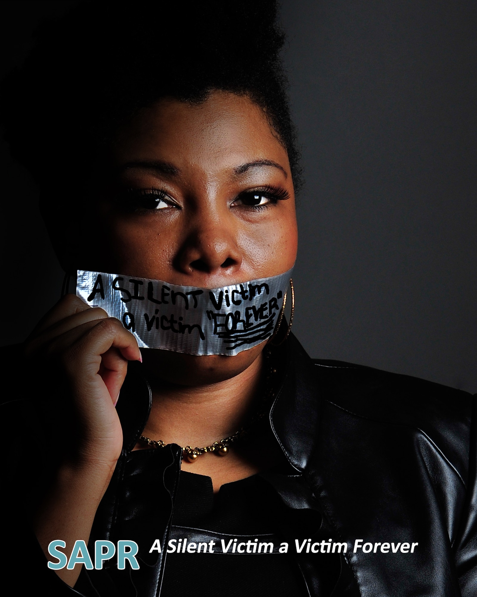 Skytina Felder-Jones poses for a photo to communicate her stance on sexual assault Mar. 12, 2014, at Kunsan Air Base, South Korea. Felder-Jones shared her experience with others so they are aware of their options and that there is life after an assault. Felder-Jones is an 8th Fighter Wing Resilience Program specialist and facilitator. (U.S. Air Force illustration/Senior Airman Armando A. Schwier-Morales)