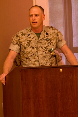 Petty Officer 1st Class Lance S. Wyatt , an El Paso, Ark. native, and corpsman with 2nd Dental Battalion, 2nd Marine Logistics Group, II Marine Expeditionary Force speaks to an audience after receiving the Navy and Marine Corps Commendation Medal with combat distinguishing device during an award ceremony aboard Camp Lejeune, N.C., April 2, 2014. Wyatt triaged, treated, and stabilized 32 urgent Afghan National Army, police and civilian casualties, saving numerous lives and significantly preserving combat power during the summer fighting season in Sangin District, Helmand province, Afghanistan, during his 2013 deployment. 