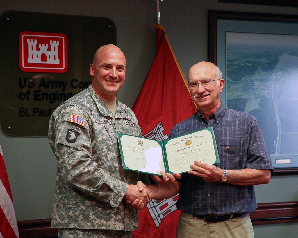 U.S. Army Corps of Engineers, St. Paul District hydraulogist and engineer Pat Foley receives a retirement certificate from Col. Dan Koprowski, district commander. Foley retired with more than 41 years of federal service.
