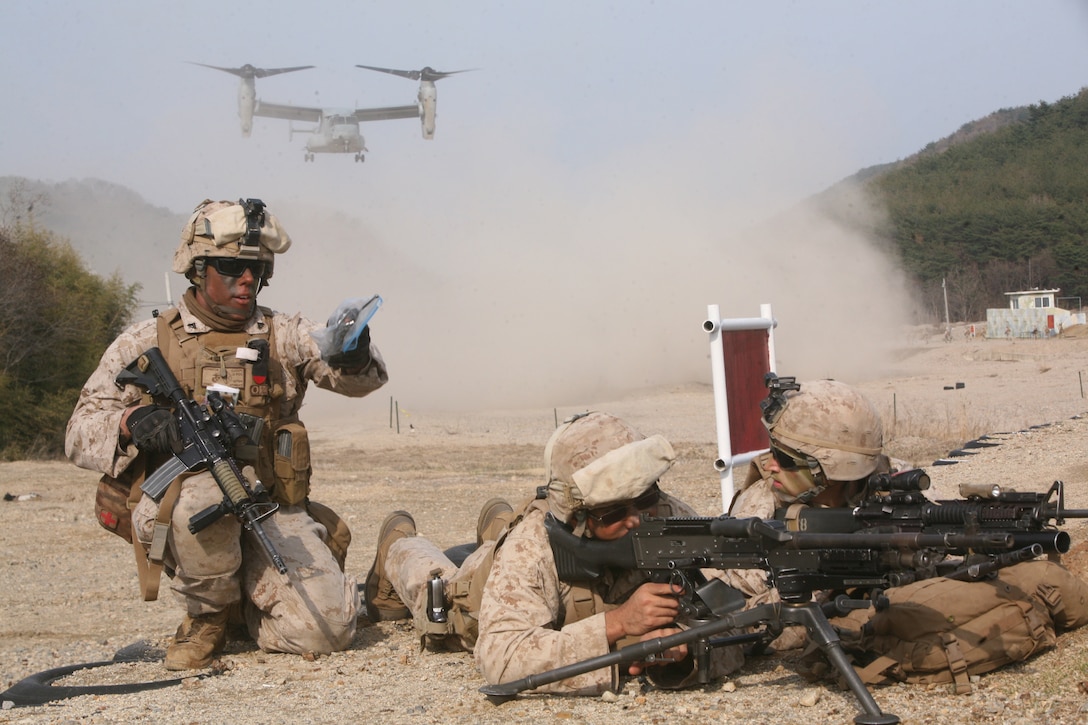 U.S. Marine Cpl. Charles J. Johnson, left, gives commands to his team during the vertical assault raid portion of exercise Ssang Yong 2014 at Su Seong-Ri Range in Pohang, Republic of Korea March 31. Ssang Yong, meaning twin dragons, exercises the interoperability and combined capability of ROK and U.S. Navy and Marine Corps forces. The exercise provides valuable military training based on realistic requirements and missions expected of ROK and U.S. forces on the Korean Peninsula. Johnson is a motor vehicle operator with Company C, Battalion Landing Team 1st Battalion, 4th Marine Regiment, 13th Marine Expeditionary Unit (U. S. Marine Corps photo by Sgt. Anthony J. Kirby/Released)