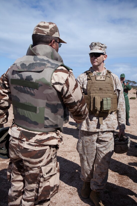 U.S. Marine Corps Brig. Gen. John K. Love, commanding general, 2nd Marine Expeditionary Brigade, II Marine Expeditionary Force greets a member of the Royal Moroccan Armed Forces (FAR) during a live fire training execrise as part of exercise African Lion 2014 on Tifnit FAR Base in Agadir, Morocco, Mar. 29, 2014. African Lion is conducted as a combined-joint exercise between the Kingdom of Morocco and the U.S. Forces to strengthen relationships and military operability in the region. (U.S. Marine Corps Photo by Cpl. Alexandria Blanche, 2D MARDIV COMCAM/Released)