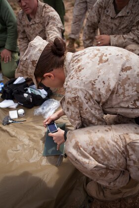 U.S. Marine Corps Lance Cpl. Chelsie A. Durfee, military policeman, 2nd Law Enforcement Battalion, 2nd Marine Expeditionary Briage, II Marine Expeditionary Force takes a picture of a finger print during a tactical site exploitation class as part of execrise African Lion 2014 on Tifnit Royal Moroccan Armed Forces Base in Agadir, Morocco, Mar. 29, 2014. African Lion is conducted as a combined joint exercise between the Kingdom of Morocco and the U.S. Forces to strengthen relationships and military operability in the region. (U.S. Marine Corps Photo by Cpl. Alexandria Blanche, 2D MARDIV COMCAM/Released)