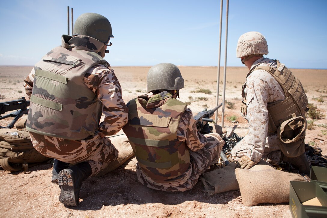 A member, center, of the Royal Moroccan Armed Forces (FAR) fires a M107 .50-caliber Special Applications Scoped Rifle during a live fire training exercise as part of exercise African Lion 2014 on Tifnit FAR Base in Agadir, Morocco, Mar. 29, 2014. African Lion is conducted as a combined joint exercise between the Kingdom of Morocco and the U.S. Forces to strengthen relationships and military operability in the region. (U.S. Marine Corps Photo by Cpl. Alexandria Blanche, 2D MARDIV COMCAM/Released)