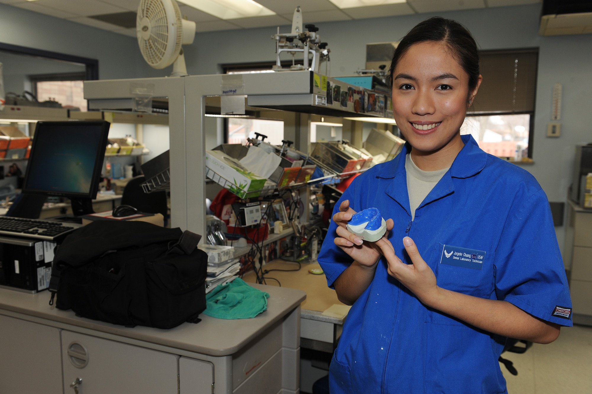 Senior Airman Jorgette Chuang displays the perfect fit of her mouth guard and dental cast at Scott Air Force Base, Ill., Feb. 19, 2014.  The process of making a mouth guard takes approximately one hour and is completed at the dental laboratory in the dental clinic.  The laboratory produced 1,300 appliances last year, including, sports guards, gold crowns, dentures, and porcelain crowns.  Chuang is a 375th Dental Squadron dental laboratory technician.  (U.S. Air Force photo by Staff Sgt. Maria Bowman)