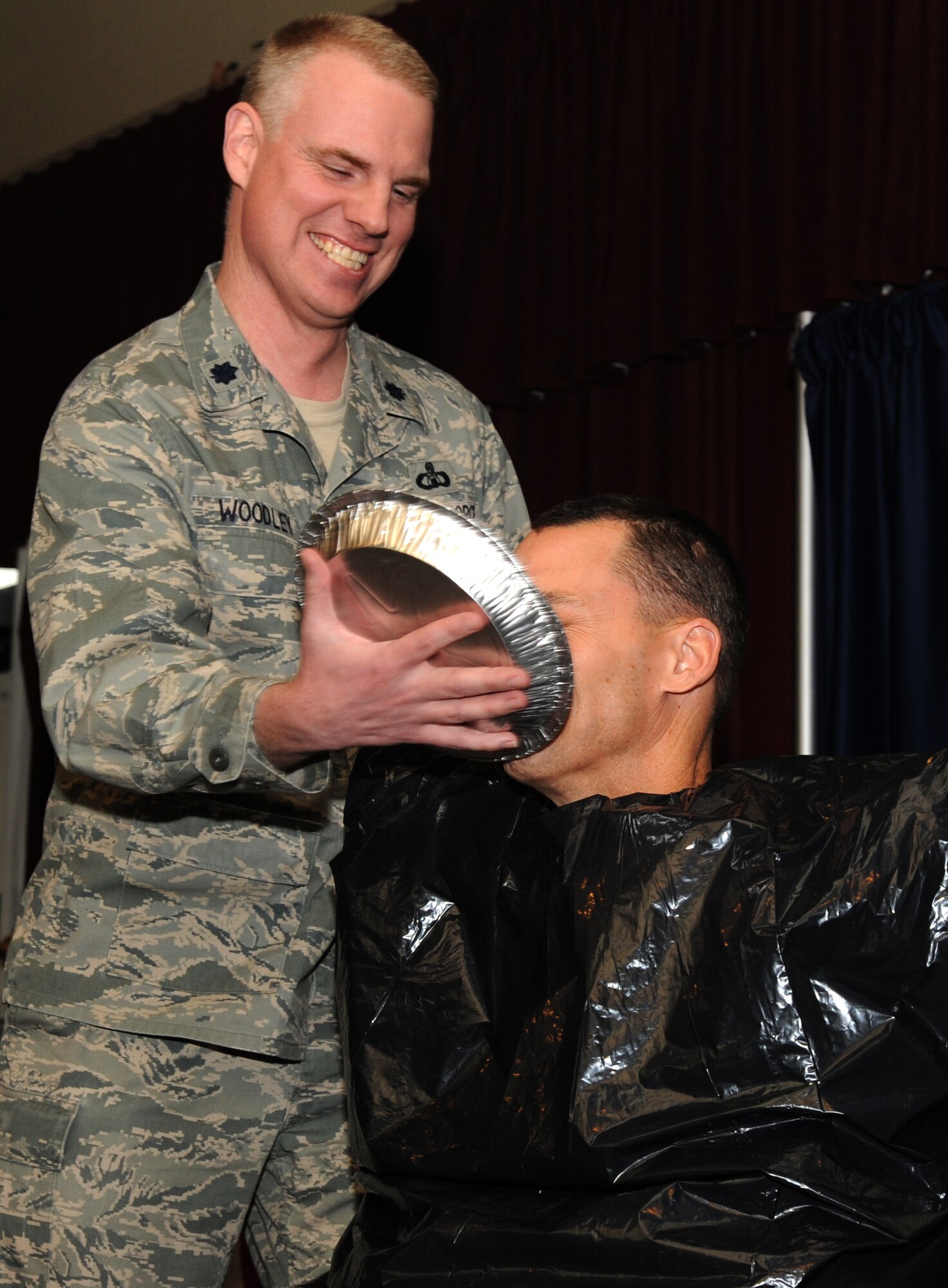 VANCE AIR FORCE BASE, Okla. – Lt. Col. David Woodley, the 71st Operations Support Squadron commander, smears his boss, Col. James Abatti, the 71st Operations Group commander, during a “Pie in the Eye” fundraiser March 26 at the Vance Collocated Club. The fundraiser brought in $817.75 for the 2014 Air Force Assistance Fund Campaign. The pies were purchased with votes and Abatti took first place with 1,727. (U.S. Air Force photo/Staff Sgt. James Bolinger)