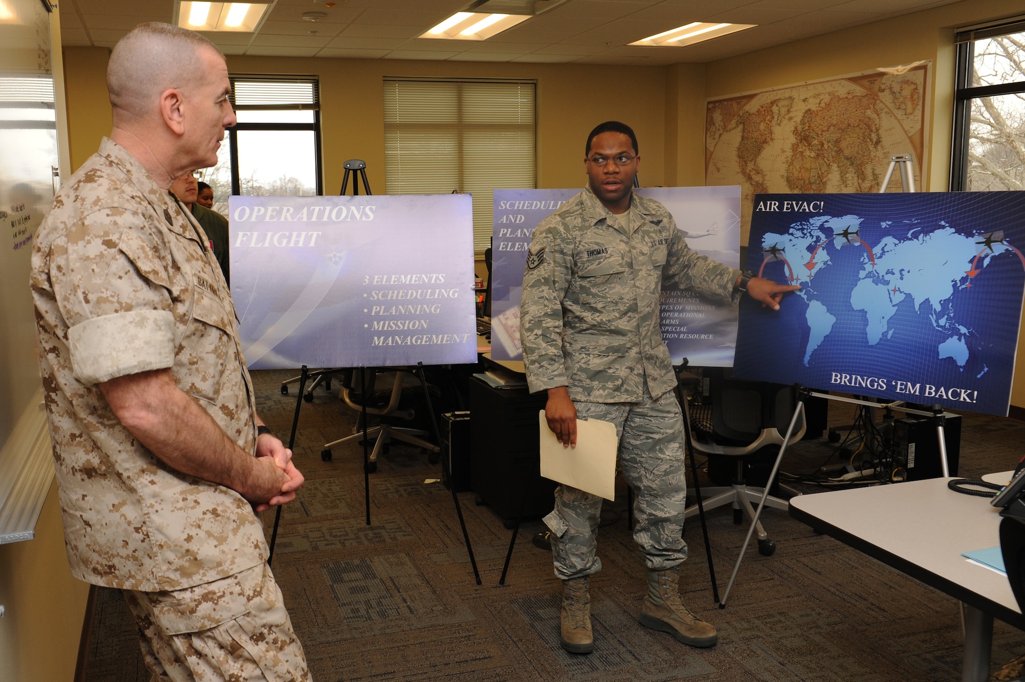 Marine Sgt. Maj. Bryan Battaglia listens to a brief about the operations at the 375th Aeromedical Evacuation Squadron, March 28, 2014, Scott Air Force Base, Ill. Battaglia learned about the AES mission and shown some of the equipment that they use. Battaglia is the Senior Enlisted Advisor to the Chairman of the Joint Chiefs of Staff. (U.S. Air Force photo/Airman 1st Class Megan Friedl)