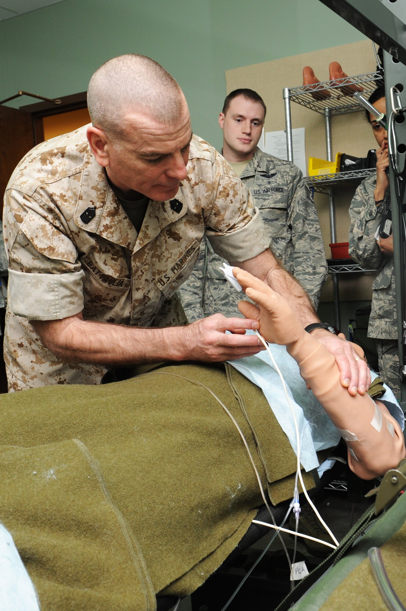 Marine Sgt. Maj. Bryan Battaglia checks vital signs and speaks with a simulated mannequin at the 375th Aeromedical Evacuation Squadron, March 28, 2014, Scott Air Force Base, Ill. Battaglia received a mission brief and tour of the building. Battaglia is the Senior Enlisted Advisor to the Chairman of the Joint Chiefs of Staff. (U.S. Air Force photo/Airman 1st Class Megan Friedl)