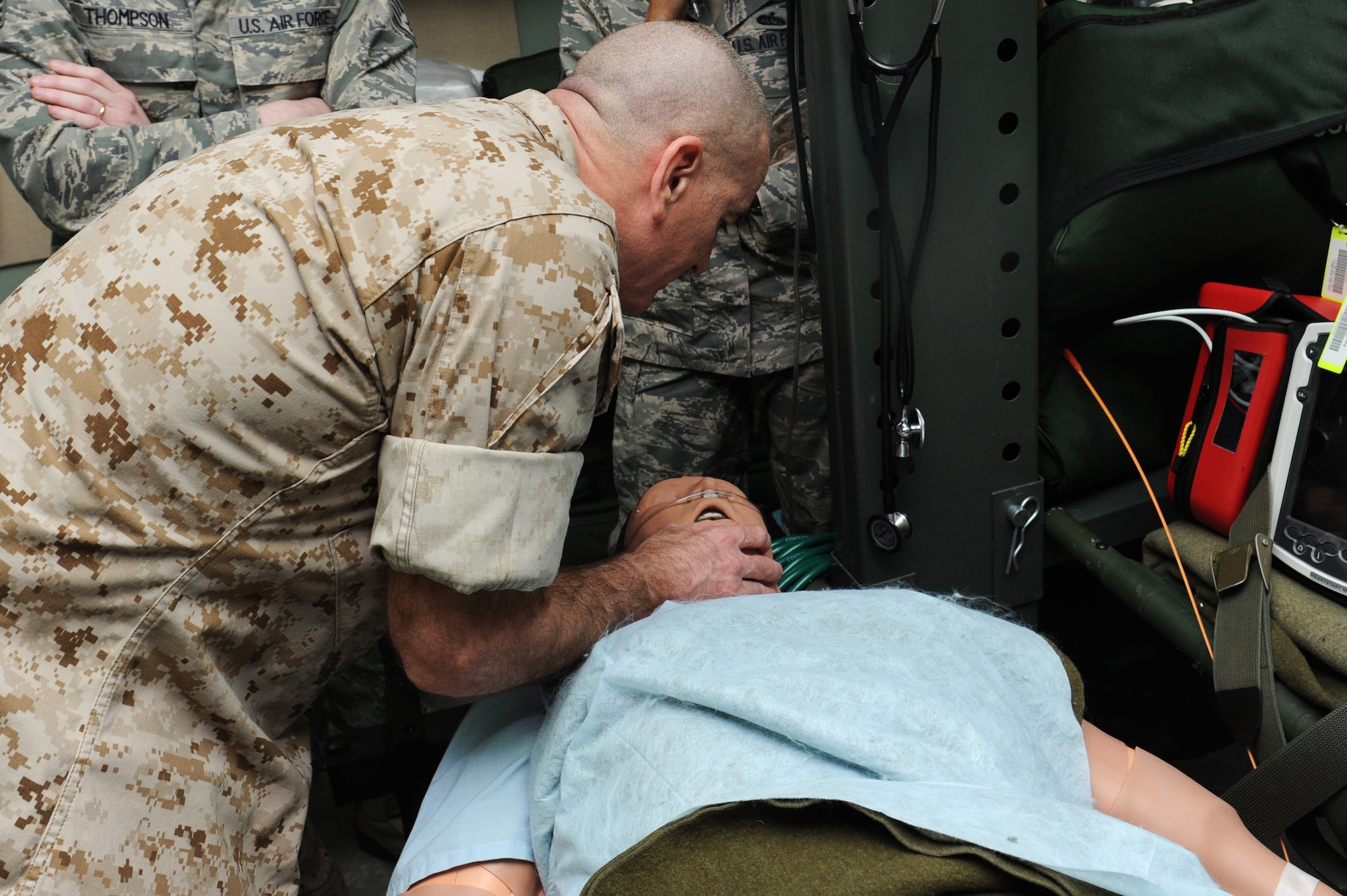 Marine Sgt. Maj. Bryan Battaglia checks vital signs and speaks with a simulated patient at the 375th Aeromedical Evacuation Squadron, March 28, 2014, Scott Air Force Base, Ill. Battaglia was briefed on the 375th AES mission and given a chance to learn how they train using simulated patients. Battaglia is the Senior Enlisted Advisor to the Chairman of the Joint Chiefs of Staff. (U.S. Air Force photo/Airman 1st Class Megan Friedl)