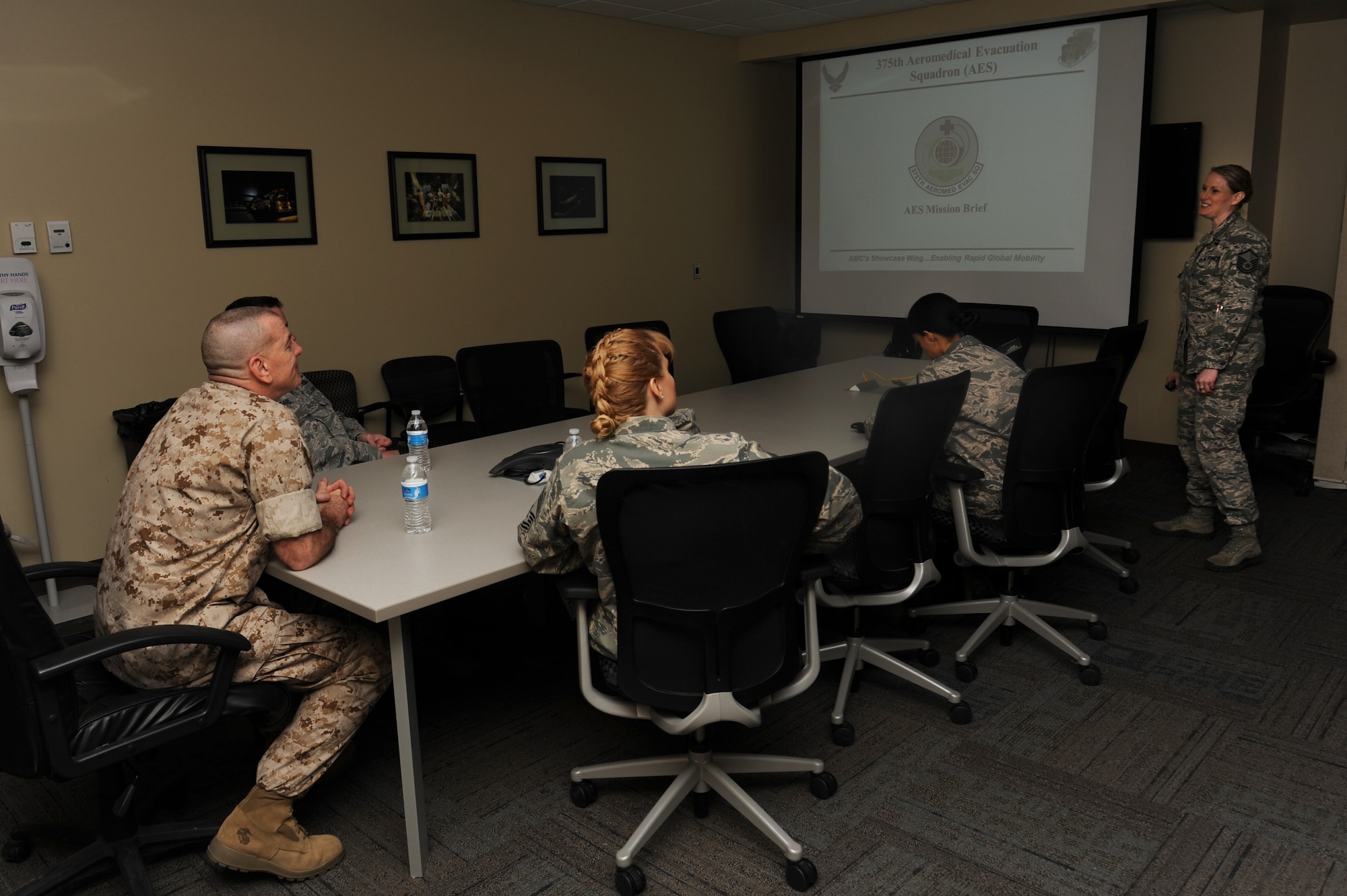 Marine Sgt. Maj. Bryan Battaglia listens to a brief about the 375th Aeromedical Evacuation Squadron mission, March 28, 2014, Scott Air Force Base, Ill. Battaglia received a tour of the building and learned about many of the procedures that the 37th AES uses while conducting their mission. Battaglia is the Senior Enlisted Advisor to the Chairman of the Joint Chiefs of Staff. (U.S. Air Force photo/Airman 1st Class Megan Friedl)