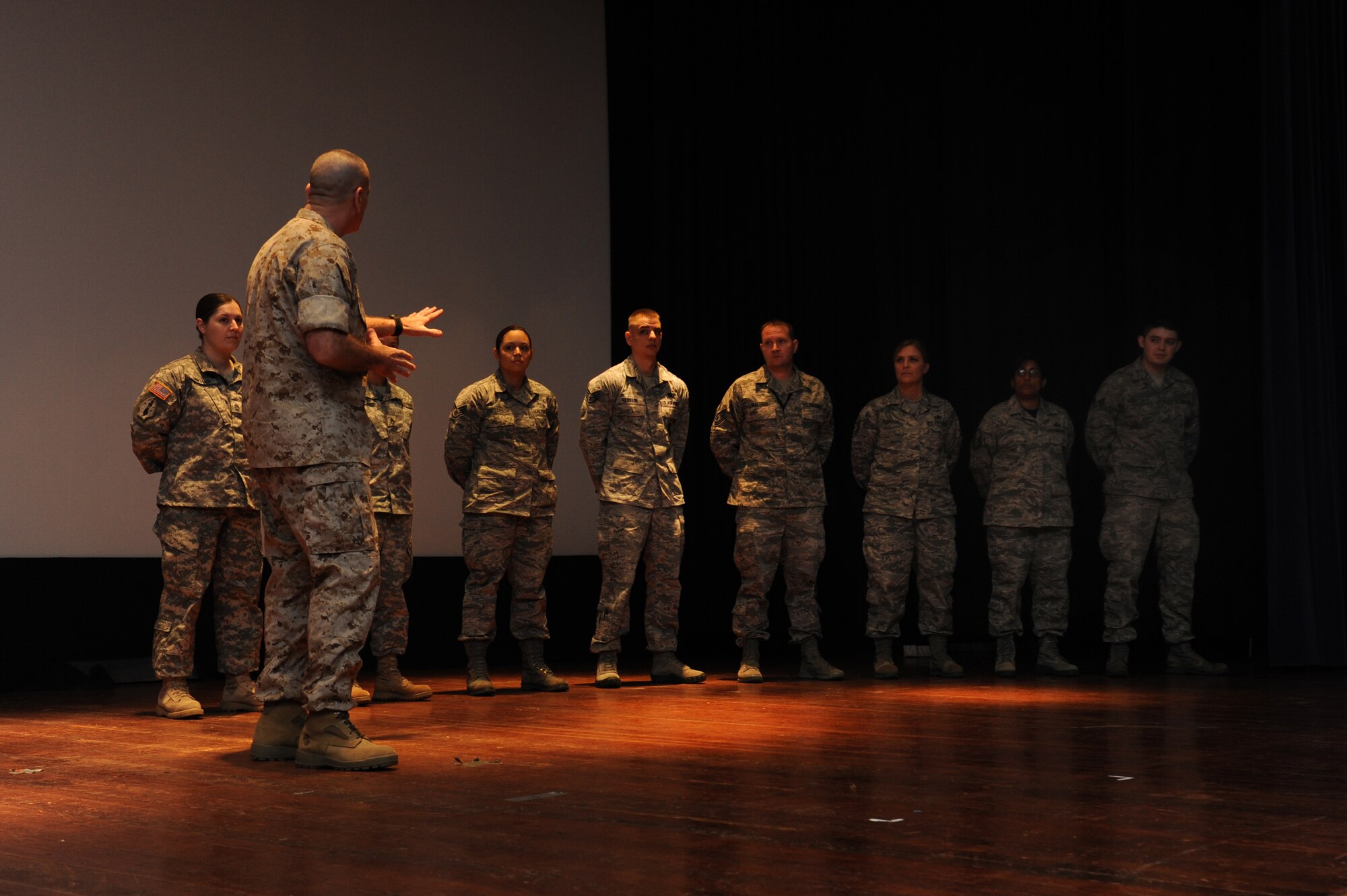 Marine Sgt. Maj. Bryan Battaglia recognizes Airmen and Soldiers for excellence at the Library Auditorium, March 28, 2014, Scott Air Force Base, Ill. Battaglia spoke about his book, "The Noncommissioned Officer and Petty Officer: The Backbone of the Armed Forces," and also answered questions from servicemembers. Battaglia is the Senior Enlisted Advisor to the Chairman of the Joint Chiefs of Staff. (U.S. Air Force photo/Airman 1st Class Megan Friedl)