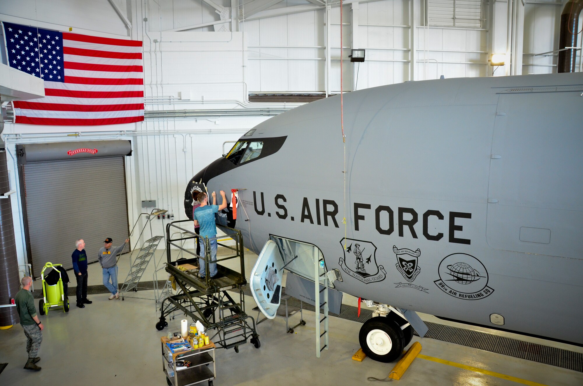 Students and directors from the University of Alabama-Birmingham paint nose art on a KC-135R aircraft. The design commemorates the 117th Air Refueling Wing's participation in the 1961 Bay of Pigs operation. Tech. Sgt. Aaron Sharit, a crew chief from the 117th Maintenance Group, created the design and was inspired by a combination of logos and graphics that were used on some of the aircraft during the invasion.  (U.S. Air National Guard photo by Master Sgt. Ken Johnson/Released)