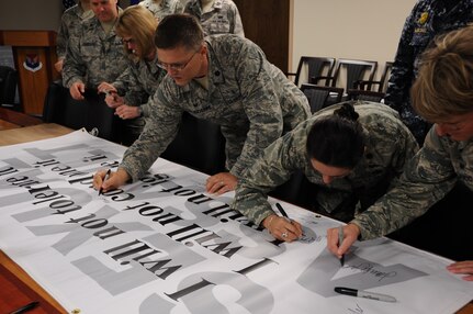 Leadership from Joint Base Charleston sign a Sexual Assault Awareness Banner April 1, 2014, at Joint Base Charleston-Air Base. The banner reads “I will not tolerate it, I will not condone it, I will not ignore it,” and will be put on display at a heavily-trafficked section of the base. (U.S. Air Force photo by 1st Lt. Christopher Love) 