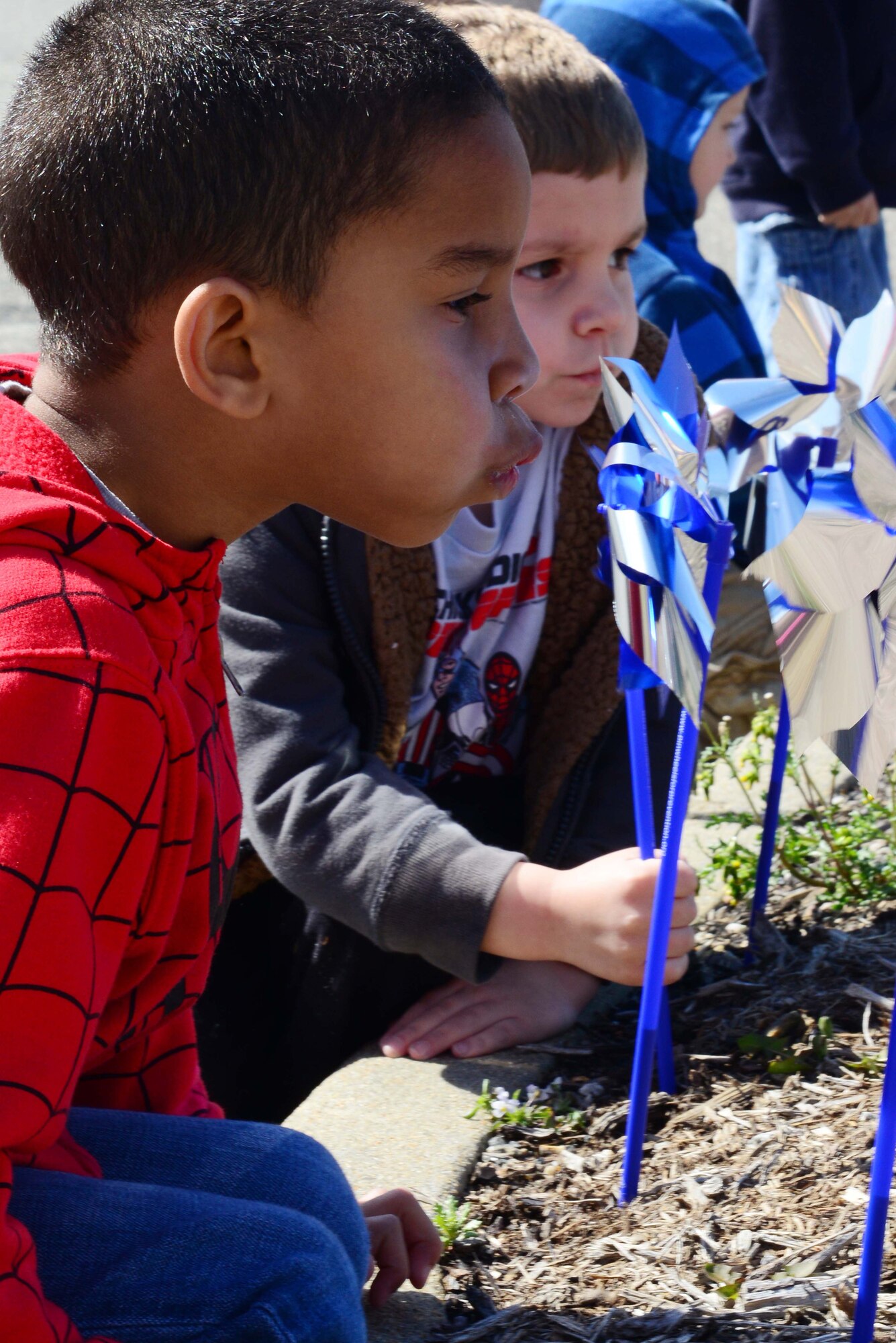 Four-year old Braylon Baranski son of Master Sgt. Sonya Martin, and Tech. Sgt. Bryon Baranski, plays with a pinwheel that was placed in the ground to help kick off National Child Abuse Prevention Month in front of the Child Development Center at Langley Air Force Base, Va., April 1, 2014.  According to the Pinwheels for Prevention campaign, the pinwheels are used as an effort to change the way communities in Virginia approach the prevention of child abuse and neglect. (U.S. photo by Airman 1st Class Kimberly Nagle/Released)