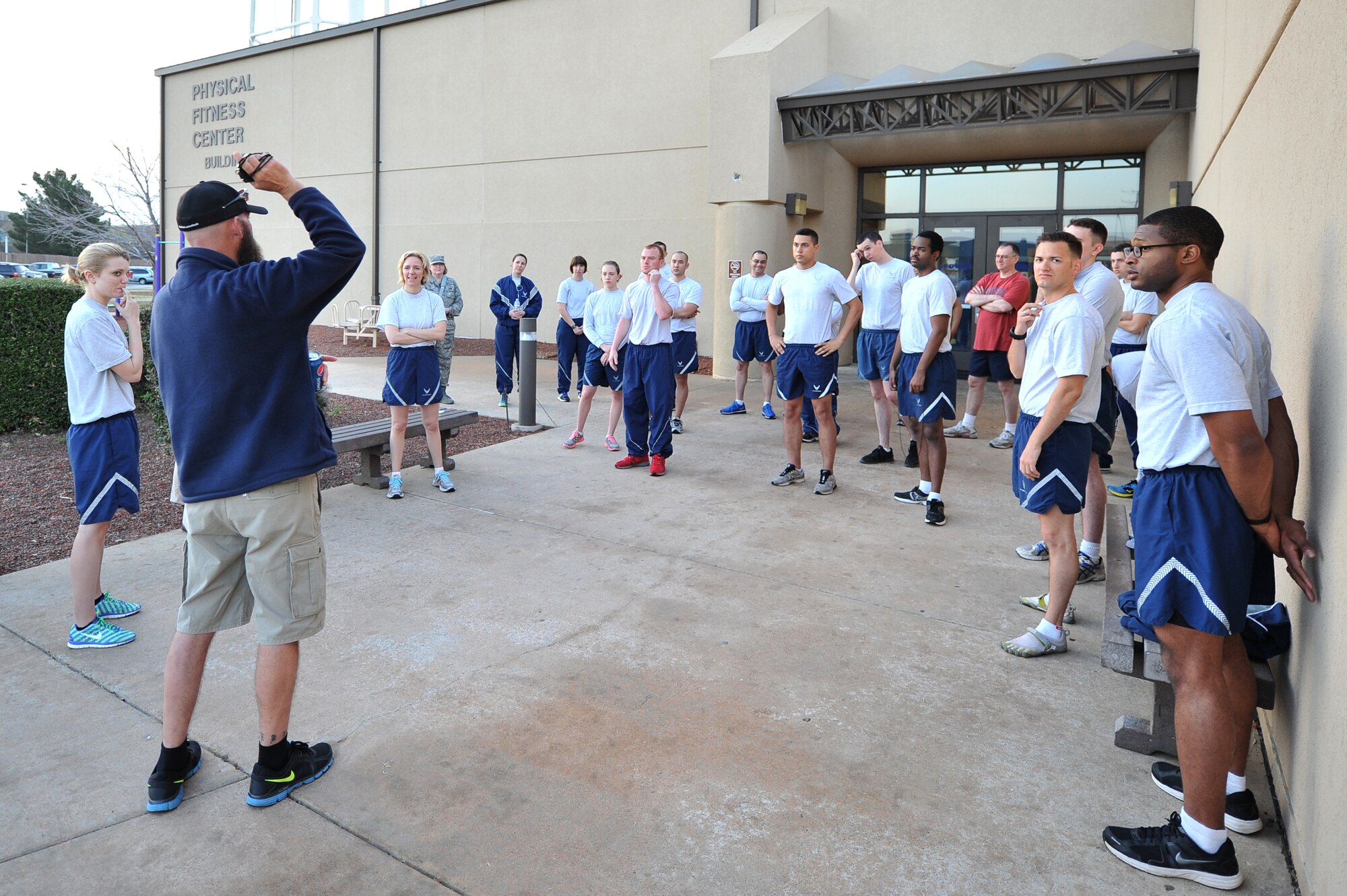 ALTUS AIR FORCE BASE, Okla. – Jeremy Stevens, 97th Force Support Squadron fitness center director, gathers participating Airmen before a five-kilometer awareness run outside the Fitness Center April 2, 2014. The event was put on with coordination of the 97th Air Mobility Wing Sexual Assault Prevention and Response Office and hosted by the fitness center to kick off Sexual Assault Awareness Month. (U.S. Air Force photo by Senior Airman Dillon Davis/Released)