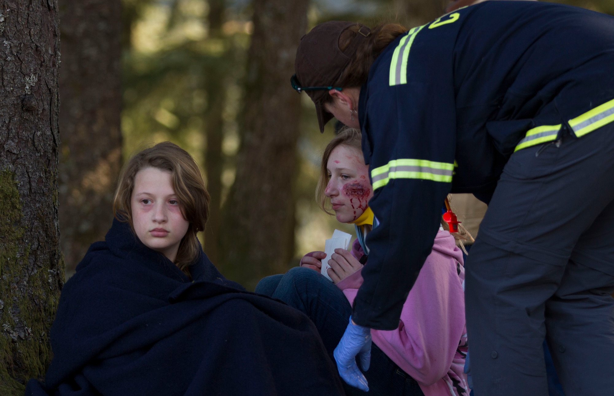An EMT with the Cordova Volunteer Fire Department provides care to members of Girl Scout Troop 285 after they were pulled from the debris of a simulated roof collapse at The Red Dragon as part of a mock disaster drill in conjunction with Alaska Shield 14 here, March 28, 2014. Alaska Shield 14 is an exercise that involves state, federal, military and local agencies, designed to test the response and coordination of the disaster modeled after the 1964 earthquake and subsequent tsunami that devastated much of South Central Alaska including the city of Cordova. (U.S. Army photo by Sgt. Shane Dorschner)