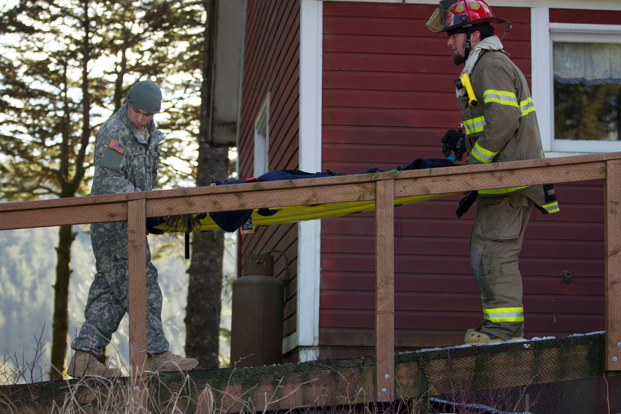 Members of the Cordova Volunteer Fire Department and Alaska National Guard soldiers from A-troop, 1-297th Reconnaissance and Surveillance Squadron extricate girl scouts with Troop 285 from a roof collapse at The Red Dragon as part of a mock disaster drill in conjunction with Alaska Shield 14 here, March 28, 2014. Alaska Shield 14 is an exercise that involves state, federal, military and local agencies, designed to test the response and coordination of the disaster modeled after the 1964 earthquake and subsequent tsunami that devastated much of South Central Alaska including the city of Cordova. (U.S. Army photo by Sgt. Shane Dorschner)