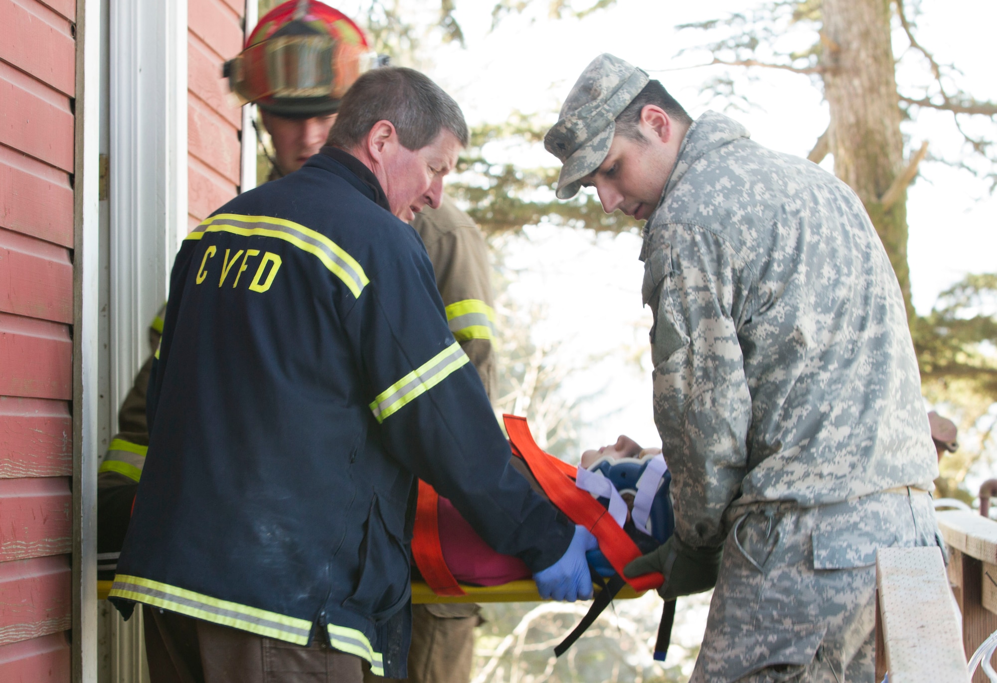 Members of the Cordova Volunteer Fire Department and Alaska National Guard soldiers from A-troop, 1-297th Reconnaissance and Surveillance Squadron extricate girl scouts with Troop 285 from a roof collapse at The Red Dragon as part of a mock disaster drill in conjunction with Alaska Shield 14 here March 28, 2014. Alaska Shield 14 is an exercise that involves state, federal, military and local agencies, designed to test the response and coordination of the disaster modeled after the 1964 earthquake and subsequent tsunami that devastated much of South Central Alaska including the city of Cordova. (U.S. Army photo by Sgt. Shane Dorschner)