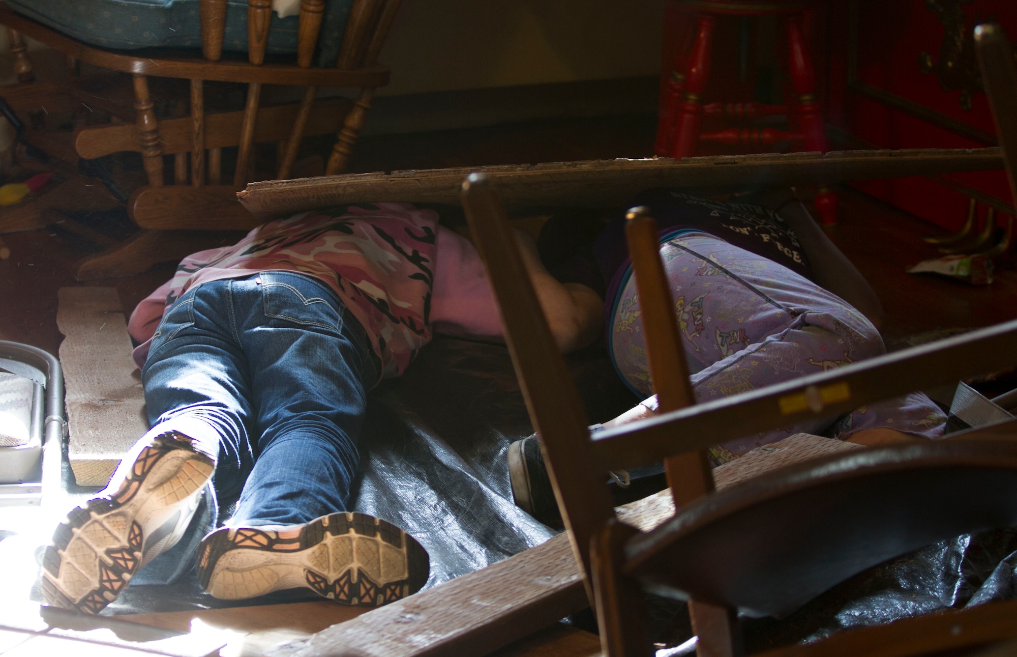 Members of Girl Scout Troop 285 participate in a mock disaster drill by  pretending to be victims of a roof collapse at The Red Dragon in conjunction with Alaska Shield 14 here March 28, 2014.  Alaska Shield 14 is an exercise that involves state, federal, military and local agencies, designed to test the response and coordination of the disaster modeled after the 1964 earthquake and subsequent tsunami that devastated much of South Central Alaska including the city of Cordova. (U.S. Army photo by Sgt. Shane Dorschner)