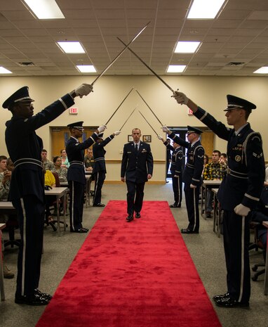 Senior Airman Austin Overbaugh, 628th Air Base Wing Honor Guard graduate, marches down the aisle during the Class 14-A Honor Guard Graduation March 28, 2014, at the Education Center on Joint Base Charleston – Air Base, S.C. These Airmen participated in a grueling two-week training course where they learned how to perform and perfect the different ceremonies that Honor Guard members take part in such as wreath ceremonies or Military Funeral Honors. (U.S. Air Force photo/ Airman 1st Class Clayton Cupit)