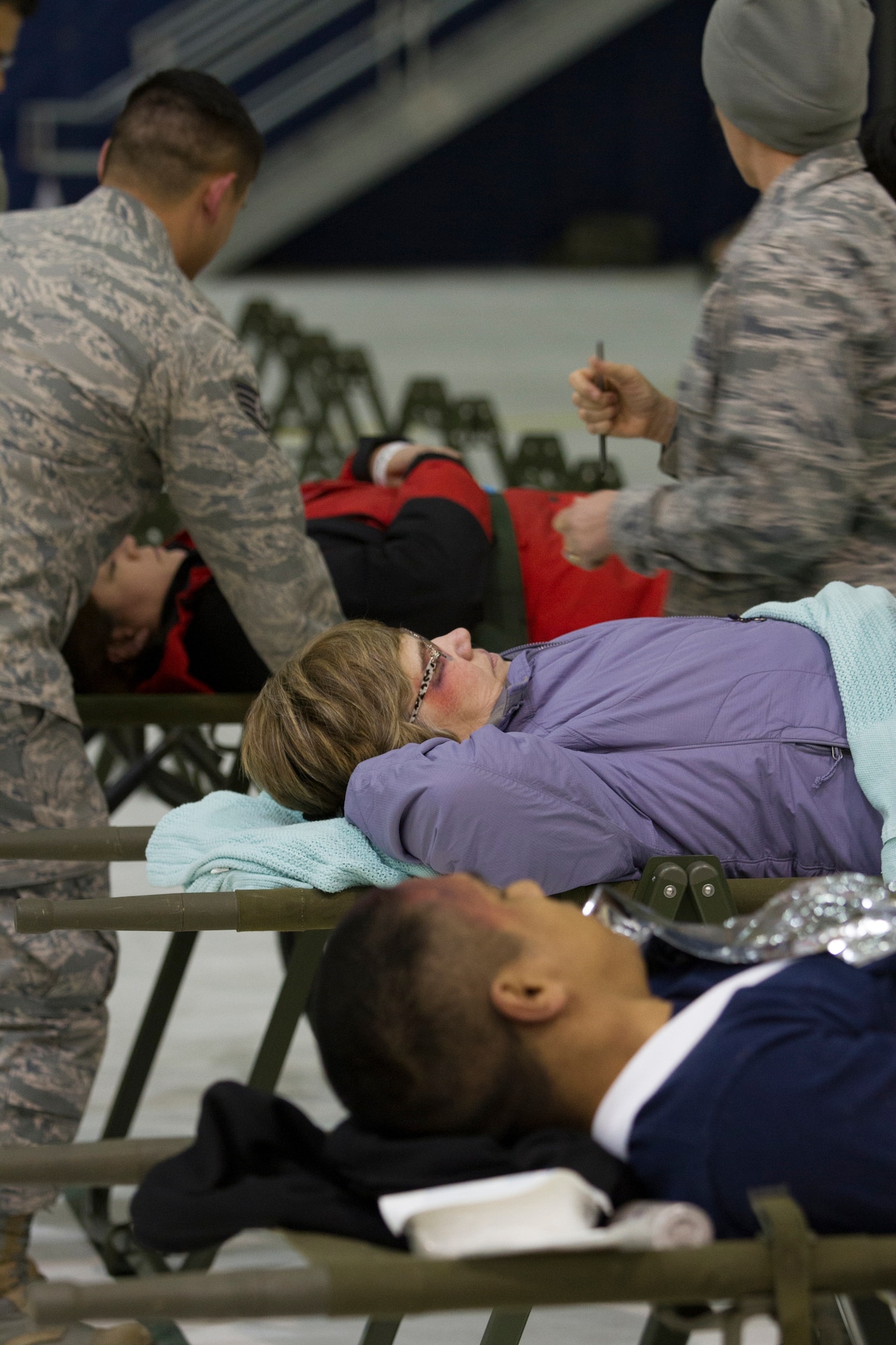 Simulated trauma victims are treated at the Disaster Aeromedical Staging Facility and evacuated by members of the Air Force as part of Alaska Shield 14 here, March 31, 2014.  The role players originated in Kodiak, Alaska, to exercise patient triage and movement procedures there before being flown to Anchorage for further processing. Alaska Shield 14 is an exercise that involves state, federal, military and local agencies, designed to test the response and coordination of the disaster modeled after the 1964 earthquake and subsequent tsunami that devastated much of South Centeral Alaska. (U.S. Army photo by Sgt. Shane Dorschner)