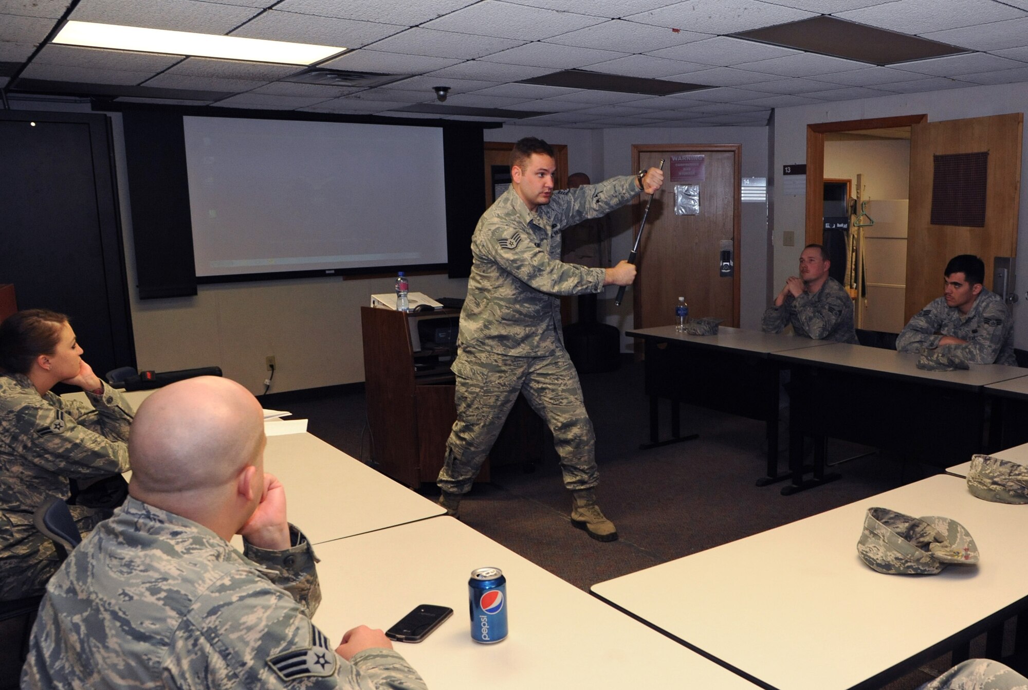 Staff Sgt. John King, the 71st Security Forces unit training manager, demonstrates a defensive maneuver with an impact baton during augmentee training March 24 at Vance Air Force Base, Okla. Baton training is one of the culminating events before augmentees are certified to support SFS during emergency operations. Each year, the 71st SFS trains 24 Airmen from different squadrons across Vance to bolster their numbers in case of emergency. (U.S. Air Force photo/ Senior Airman Frank Casciotta)