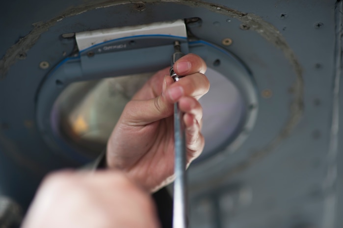 Senior Airman Cole Lumadue, 437th Aircraft Maintenance Squadron crew chief, replaces a light on the wing of a C-17 Globemaster III, March 25, 2014, at Joint Base Charleston S.C. The large formation exercise provided more than 500 operational and maintenance training objectives and demonstrated the U.S. Air Force's strategic capability. (U.S. Air Force photo/ Staff Sgt. William A. O’Brien)