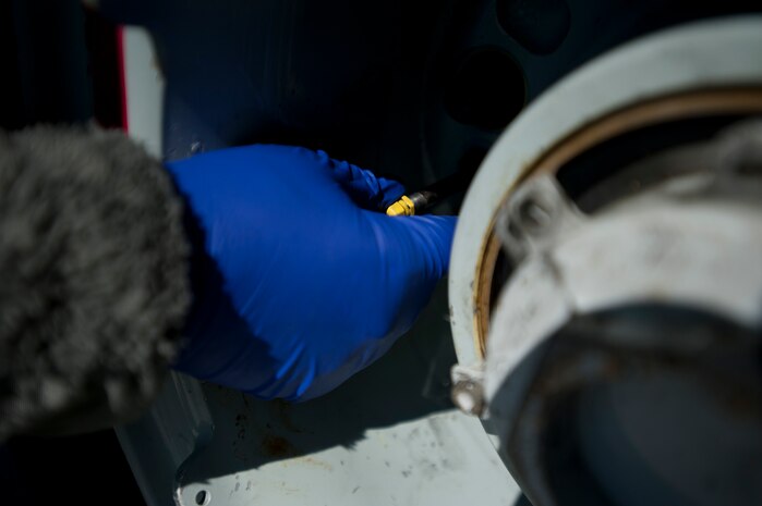 Airman 1st Class Brittany Emberton, 437th Aircraft Maintenance Squadron assistant dedicated crew chief, checks the tire pressure of a Globemaster III C-17 in preparation for a large scale formation exercise March 26, 2014, at Joint Base Charleston, S.C. The large formation exercise provided more than 500 operational and maintenance training objectives and demonstrated the U.S. Air Force's strategic capability. (U.S. Air Force photo/ Staff Sgt. William A. O’Brien)