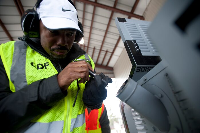 Virgil Parks, 437th Aerial Port Squadron hazardous material inspector, inspects the gas tank of a piece of cargo during an exercise March 26, 2014, at Joint Base Charleston – Air Base, S.C. The cargo prepared by 437th APS was used in a large formation exercise which provided more than 500 operational and maintenance training objectives and demonstrated the U.S. Air Force's strategic capability. (U.S. Air Force photo/ Staff Sgt. William A. O’Brien)