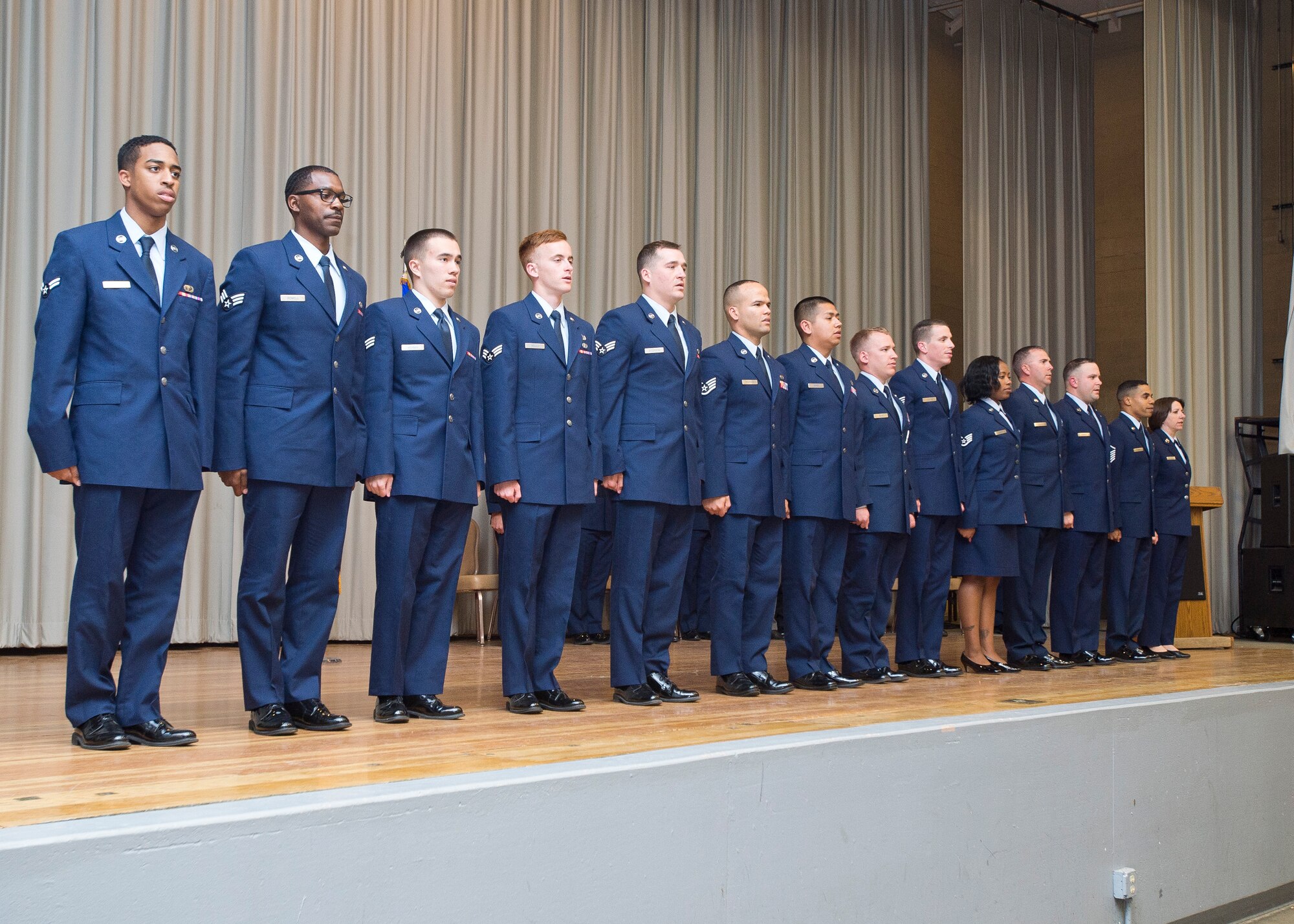 Team Edwards' March promotees sing the Air Force Song at the base theater March 28 after pinning on their new ranks. (U.S. Air Force photo by Ethan Wagner)