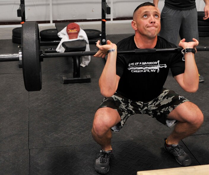 Maj. Jesse Goens, 99th Ground Combat Training Squadron commander, performs front squats at the functional fitness workout class with the Life of a Warrior campaign on Creech Air Force Base, Nev., March 28, 2014. The class focuses on a cross-fit style of workout to help improve overall fitness for the Airmen who participate. (U.S. Air Force photo by Airman 1st Class C.C./Released) 