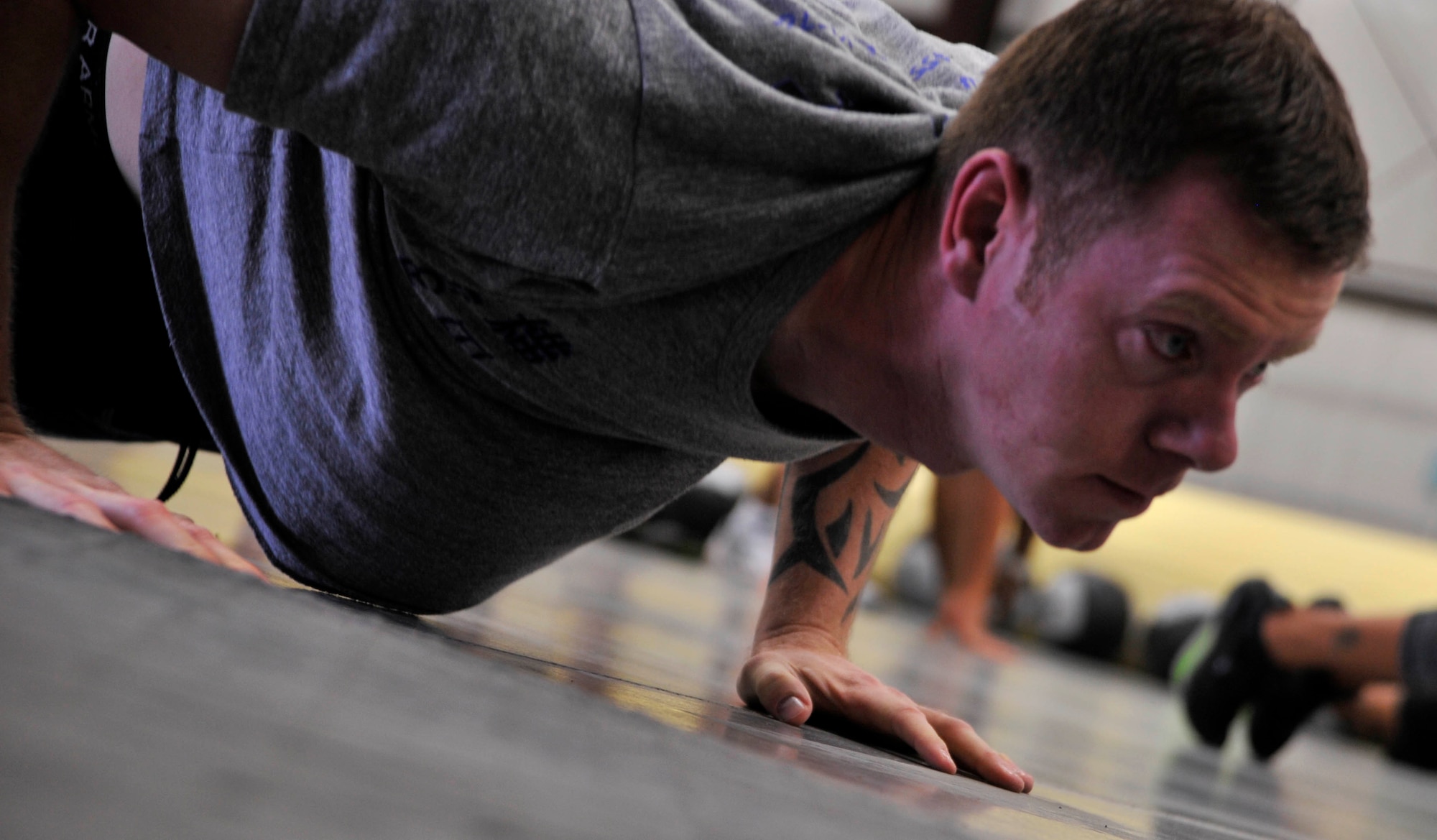 Tech. Sgt. Paul Bro, assigned to the 799th Air Base Squadron, participates in a warm up exercise during a workout at the Life of a Warrior campaign on Creech Air Force Base, Nev., March 28, 2014. Life of a Warrior features many different fitness groups to help improve Airmen fitness and strength. (U.S. Air Force photo by Airman 1st Class C.C./Released)