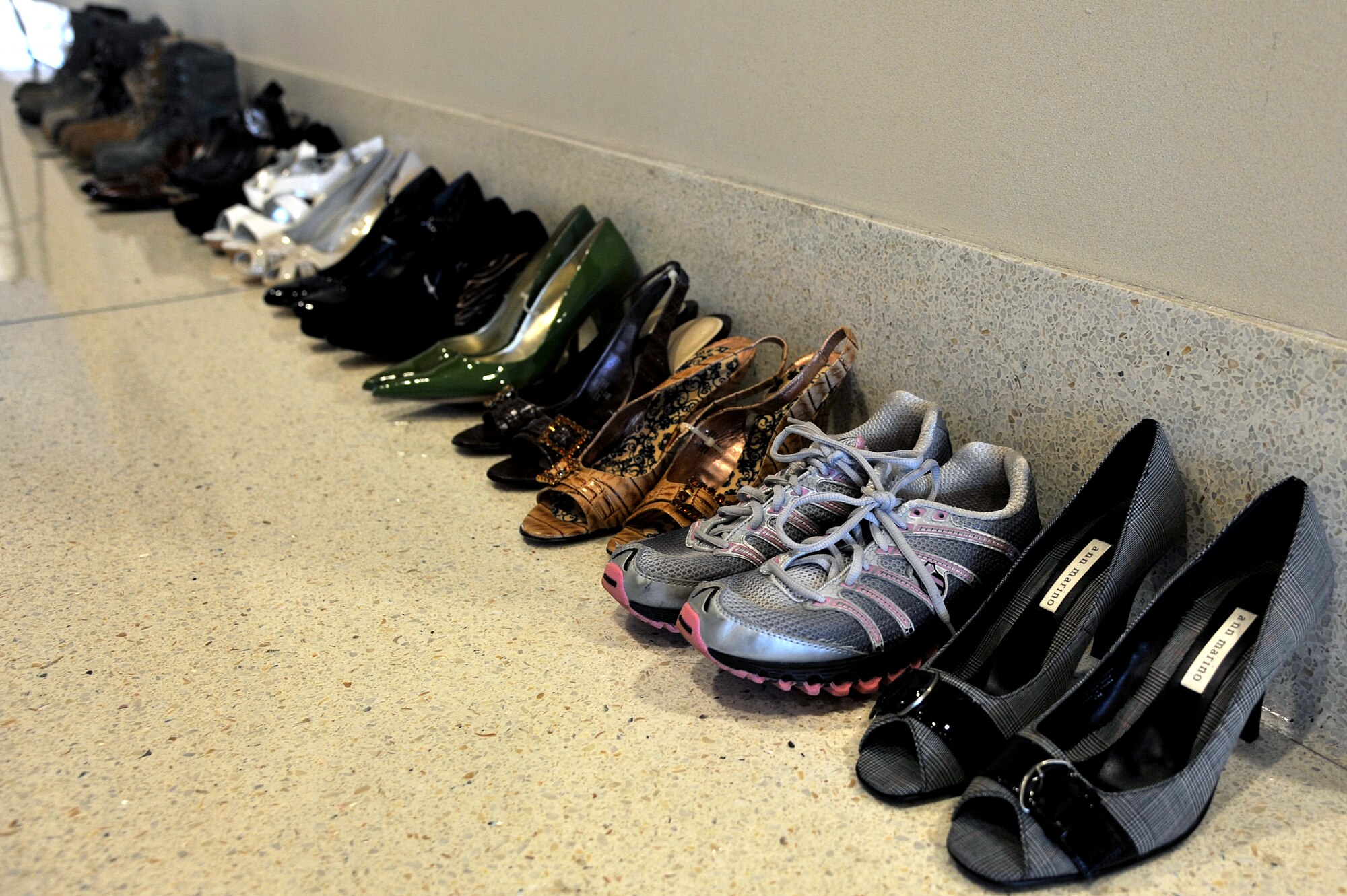 Shoes line a corridor at USAF Hospital Langley during the Sexual Assault and Prevention fair at Langley Air Force Base, Va., April 2, 2014. The shoes represent victims of sexual assault and were displayed as part of the SAPR response team’s effort to raise awareness and promote the prevention of sexual violence (U.S. Air Force photo by Senior Airman Kayla Newman/Released)