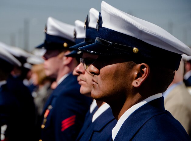 Current and former United States Coast Guard Cutter Gallatin (WHEC-721) crewmembers, stand at attention as the cutter is formally decommissioned March 31, 2014, in Charlston, S.C.  The Gallatin is being transferred to the Nigerian Navy following its decommissioning.  (U.S. Air Force photo/ Staff Sgt. Aaron Thomasson)