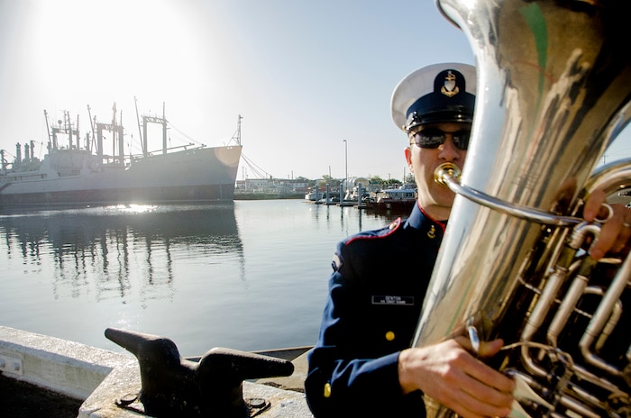 United States Coast Guard Senior Chief Petty Officer Rich Denton, a musician, tunes up before playing at the decommissioning ceremony of United States Coast Guard Cutter Gallatin (WHEC-721), March 31, 2014 in Charleston, S.C.  The Gallatin is being replaced by a new National Security Cutter, USCGC Hamilton (WMSL-753).  (U.S. Air Force photo/ Staff Sgt. Aaron Thomasson)