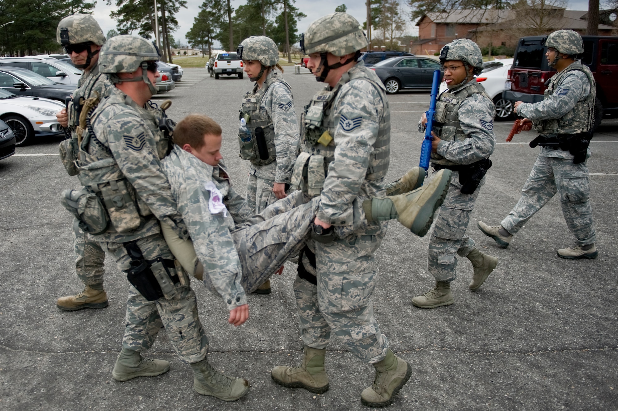 Airmen assigned to the 4th Security Forces Squadron carry a simulated dead body during an active shooter exercise, March 28, 2014 at Seymour Johnson Air Force Base, N.C.  The exercise tested the capabilities of first responders and medical professionals to respond to an on-base crisis.  (U.S. Air Force photo/Airman 1st Class Brittain Crolley)