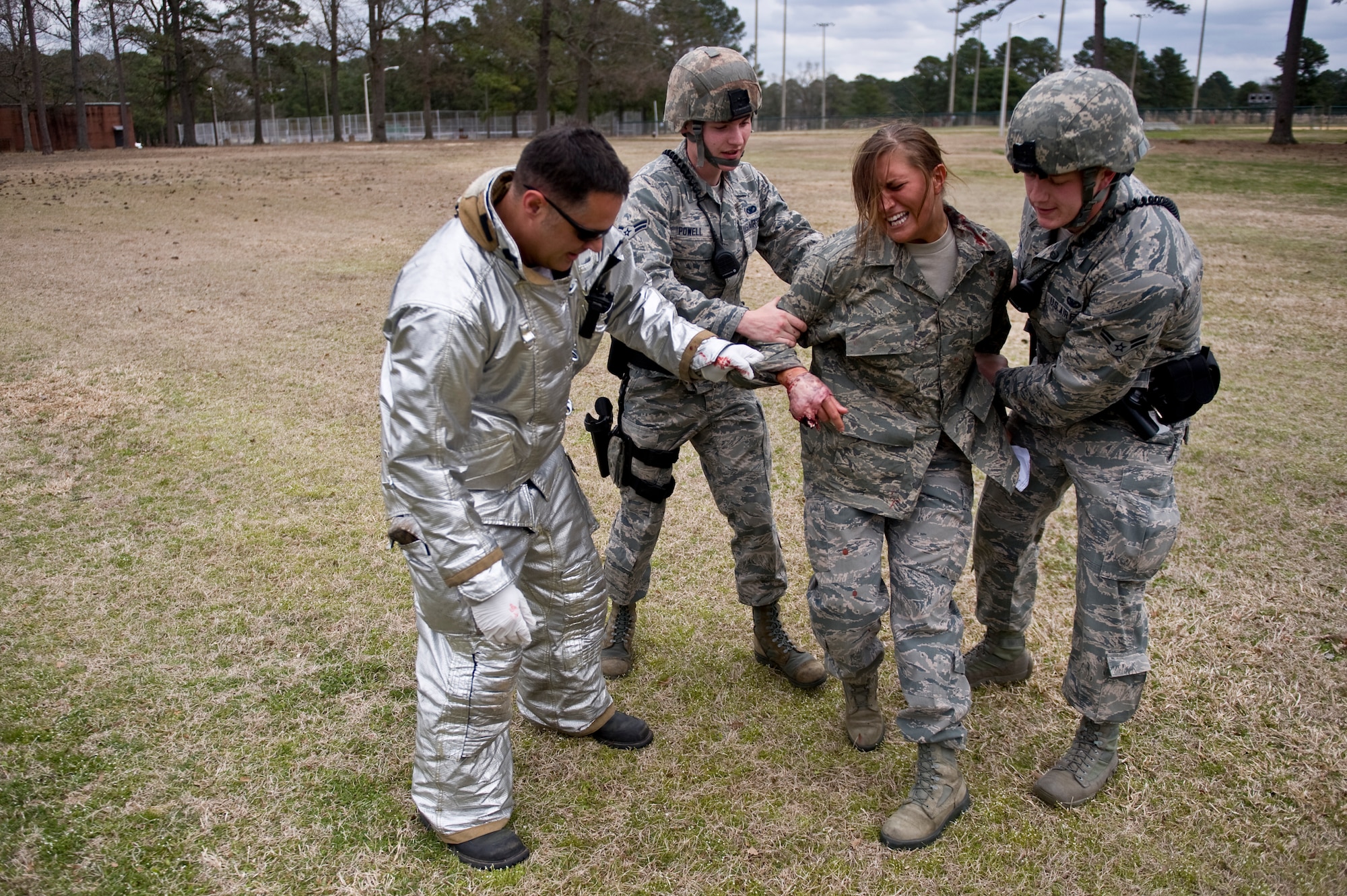 Senior Airman Emma Duff, 4th Fighter Wing Public Affairs broadcast journalist apprentice, is restrained by first responders during an active shooter exercise, March 28, 2014 at Seymour Johnson Air Force Base, N.C.  Duff’s role-played an injured victim suffering from physical and emotional trauma.  (U.S. Air Force photo/Airman 1st Class Brittain Crolley)