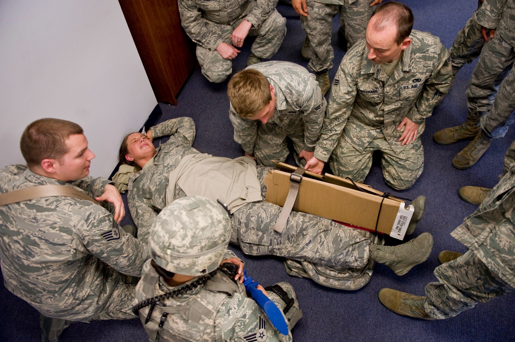 First responders and members of an Airman Leadership School class apply self-aid and buddy care to a simulated victim during an active shooter exercise, March 28, 2014 at Seymour Johnson Air Force Base, N.C.  The victim was treated for a gunshot wound to the leg.  (U.S. Air Force photo/Airman 1st Class Brittain Crolley)