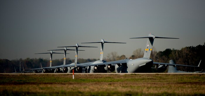 Nine C-17 Globemaster III aircraft taxi to the runway as they prepare for take- off during a large formation exercise March 27, 2014, at Joint Base Charleston, S.C. The large formation exercise provided more than 500 operational and maintenance training objectives and demonstrated the U.S. Air Force's strategic capability. (U.S. Air Force photo/ Senior Airman Dennis Sloan)
