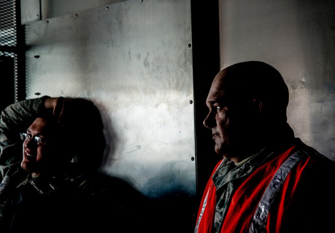 437th Aircraft Maintenance Squadron crew chiefs ride in the back of a vehicle going from spot to spot performing maintenance on C-17 Globemaster III aircraft in preparation for a large formation exercise March 25, 2014, at Joint Base Charleston, S.C. The large formation exercise provided more than 500 operational and maintenance training objectives and demonstrated the U.S. Air Force's strategic capability. (U.S. Air Force photo/ Senior Airman Dennis Sloan)