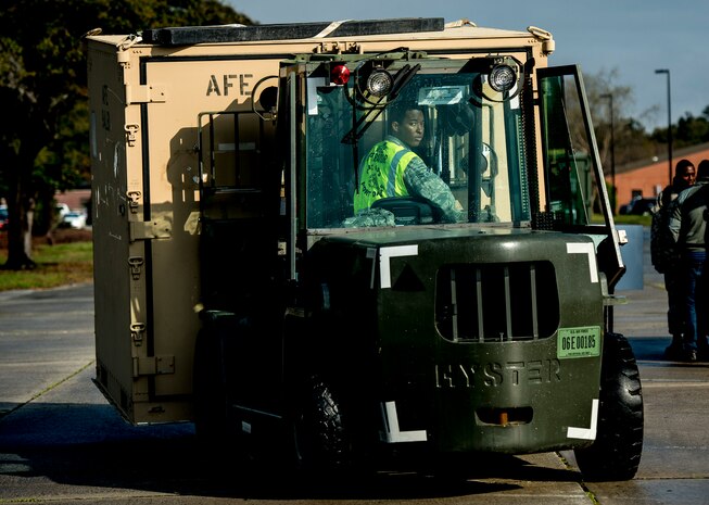Airman 1st Class John Woodruff, 437th Aerial Port Squadron cargo processing apprentice, transports a cargo container to a weighing station, March 25, 2014, at Joint Base Charleston, S.C.  The large formation exercise provided more than 500 operational and maintenance training objectives and demonstrated the U.S. Air Force's strategic capability. (U.S. Air Force photo/ Senior Airman Dennis Sloan)