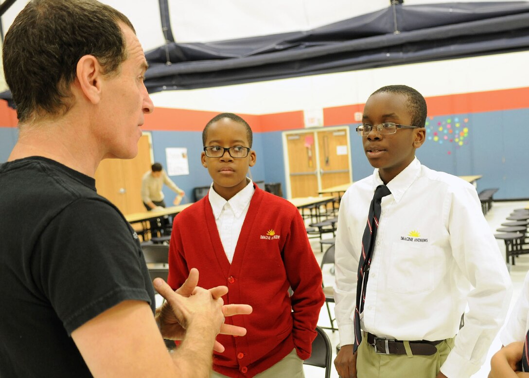 Trevor Romain, award-winning author, speaks with Jondae Smith, 12, a 6th grader, about his mother’s deployment during a visit to the Imagine Andrews Public Charter School on Joint Base Andrews, Md., March 26 as part of the 2014 “With You All The Way” Tour. The tour is in partnership with The Trevor Romain Group and the United Services Organizations (USO) to promote resiliency for children. (U.S. Air Force photo by Aimee Fujikawa)