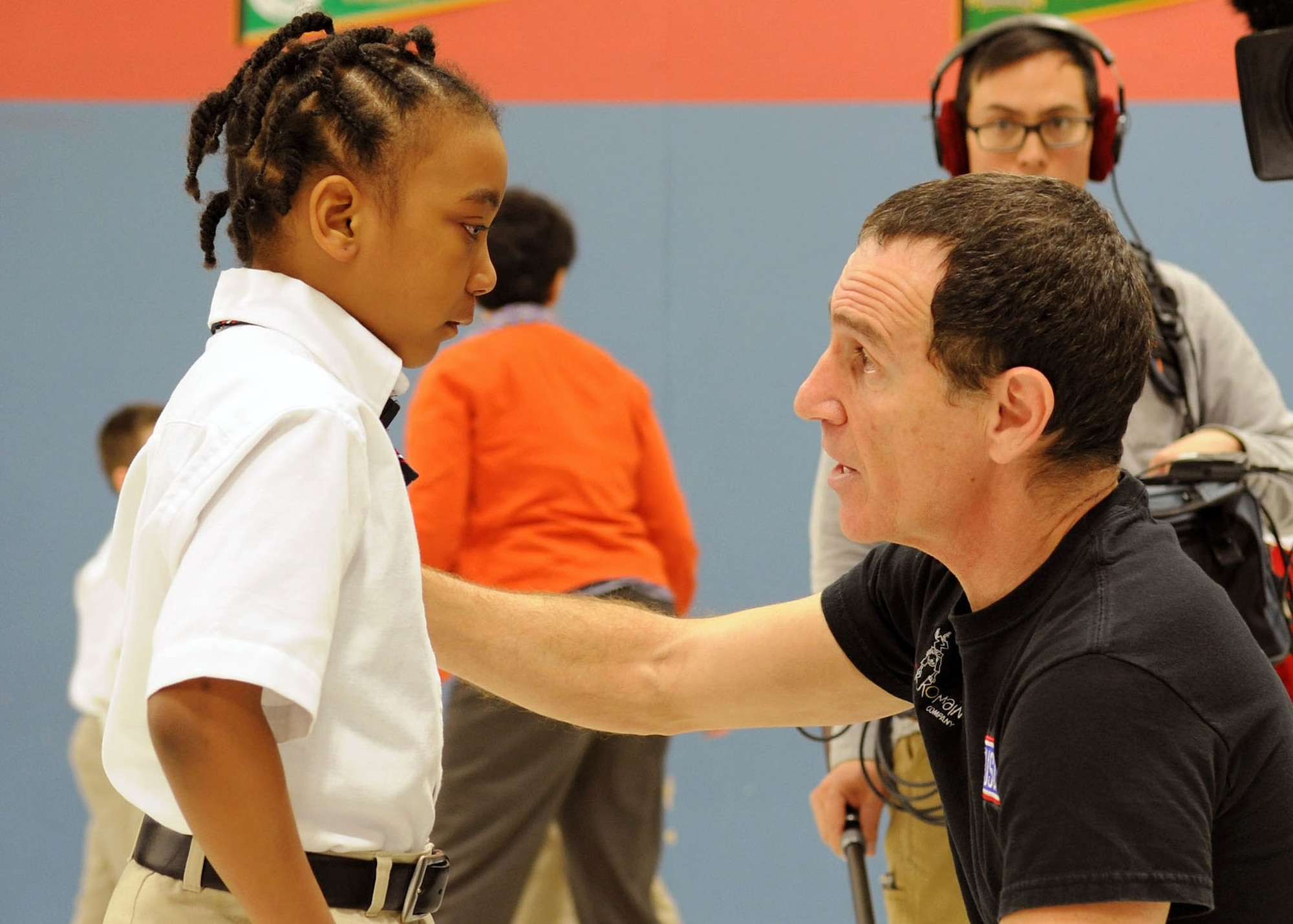 Trevor Romain, award-winning author, speaks with a student following a visit to the Imagine Andrews Public Charter School on Joint Base Andrews, Md., March 26 as part of the 2014 “With You All The Way” Tour. The tour is in partnership with the Trevor Romain Group and the United Services Organizations (USO) promote resiliency for children. (U.S. Air Force photo by Aimee Fujikawa)