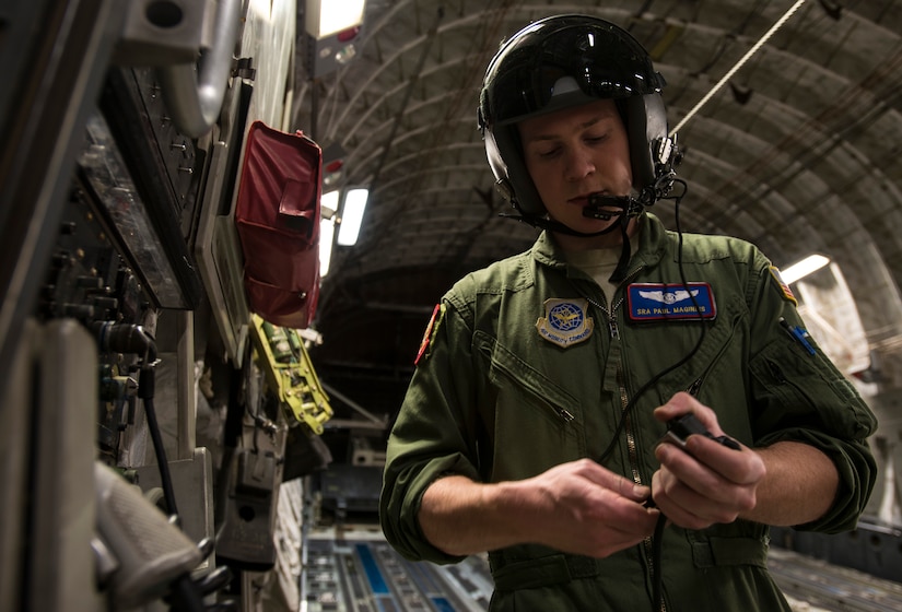 Senior Airman Paul Maginnis, 15th Airlift Squadron loadmaster, prepares his communication equipment prior to take-off March 27, 2014, on a C-17 Globemaster III at Joint Base Charleston – Air Base, S.C. The helmet provides ear protection while also allowing loadmasters to clearly communicate with other aircrew members. (U.S. Air Force photo/ Airman 1st Class Clayton Cupit)