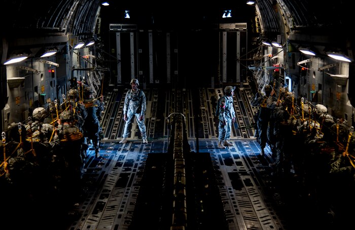 Soldiers from the 82nd Airborne Division, Ft. Bragg, N.C., wait for the green light indicating it is time to jump March 27, 2014, on a C-17 Globemaster III flying over an undisclosed location. The paratroopers were part of a large formation exercise which provided more than 500 operational and maintenance training objectives and demonstrated the U.S. Air Force’s strategic capability. (U.S. Air Force photo/ Airman 1st Class Clayton Cupit)