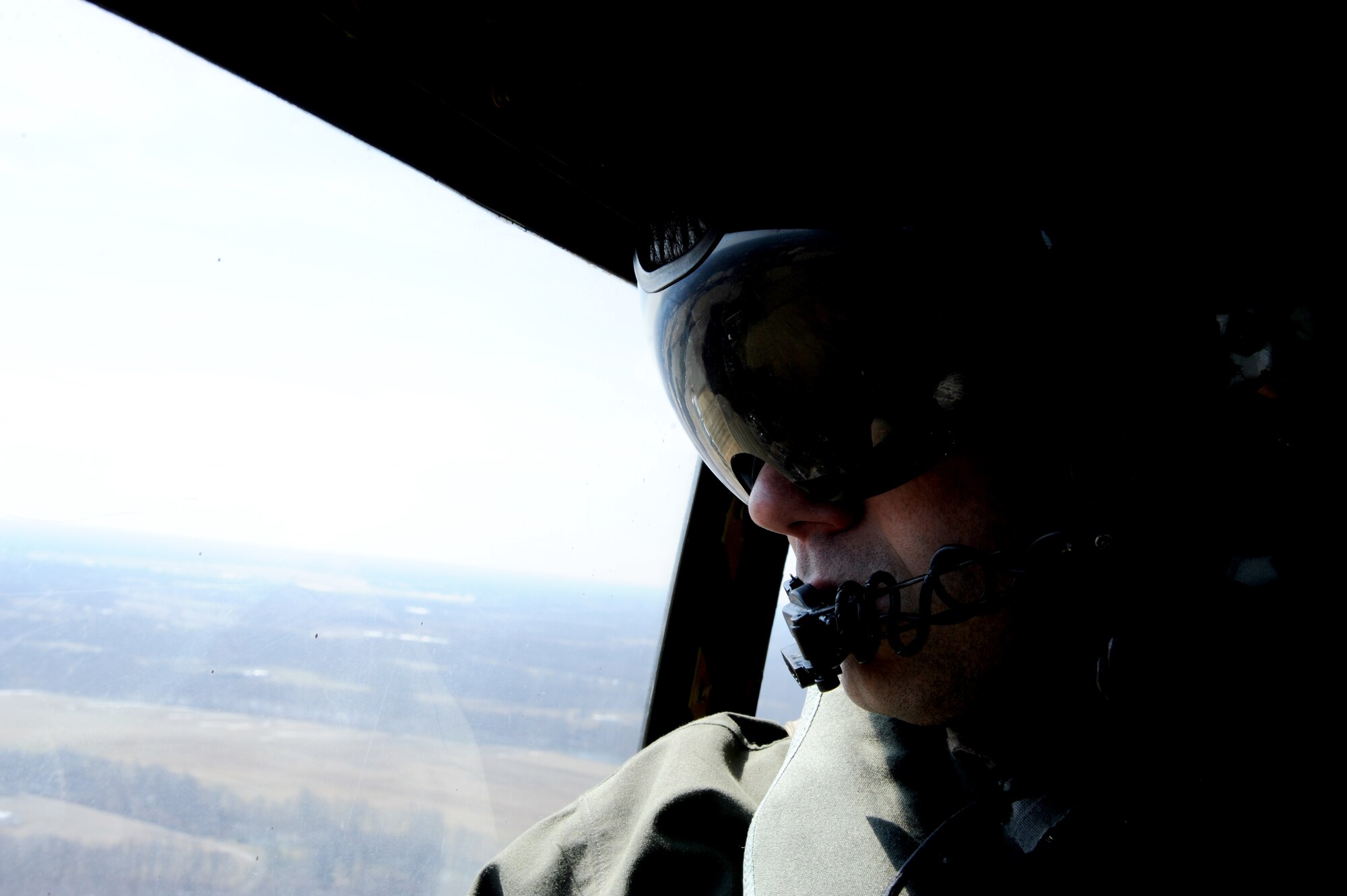 Marine Sgt. Gregory Donohoe, Marine Light Attack Helicopter Squadron (HMLA) 773 crew chief, gazes out the window of a UH-1N Huey during the squadron’s final flight of the particular Huey model March 27, 2014, out of Joint Base McGuire-Dix-Lakehurst, N.J. Marine Forces Reserve transitioned to the UH-1Y Venom model to modernize the Marines’ utility helicopter fleet. (U.S. Air Force photo by Airman 1st Class Sean M. Crowe/Released)