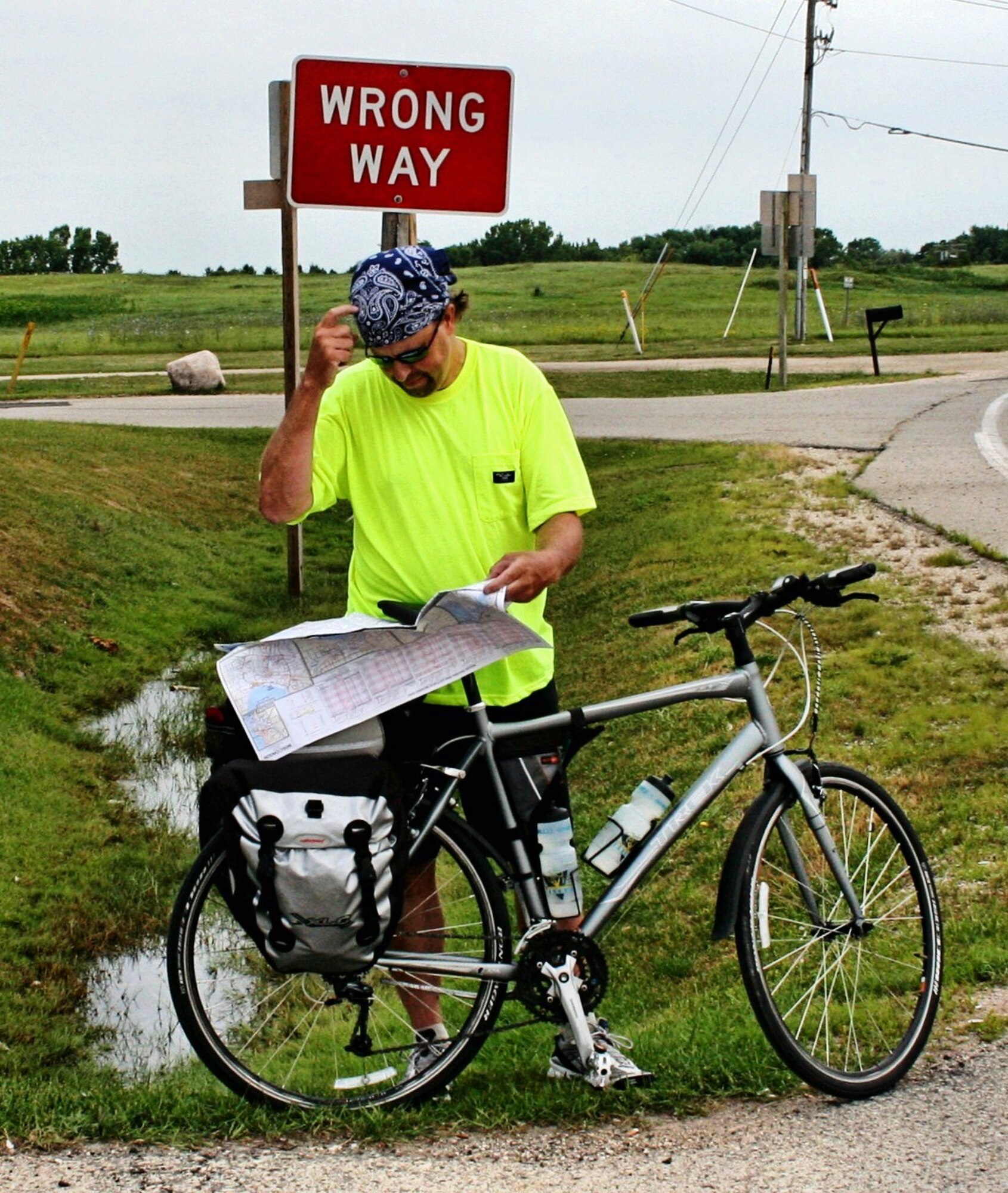 Wesley Willand reading directions on a road map in central Wisconsin during a bicycle trip across North America. (courtesy photo)