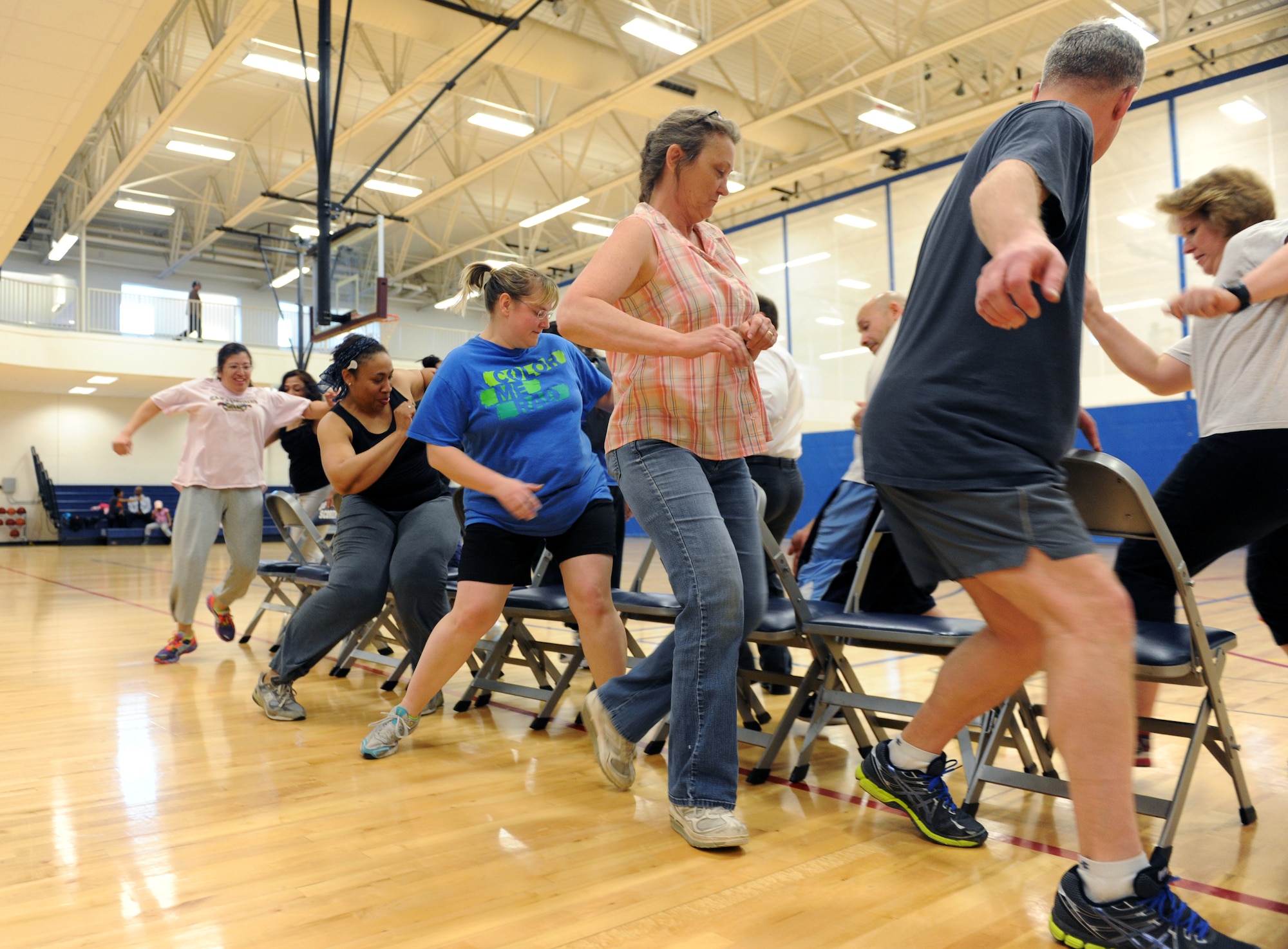 Buckley Total Fitness Challenge participants play musical chairs as part of the finale workout of the 10-week challenge April 1, 2014 at the Buckley Fitness Center on Buckley AFB, Colo. The Buckley Fitness Center began the fitness challenge as a way to motivate and promote exercising to Team Buckley members.  (U.S. Air Force photo by Airman Emily E. Amyotte/Released)